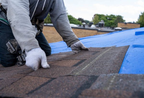 Roofers installing new roof on house